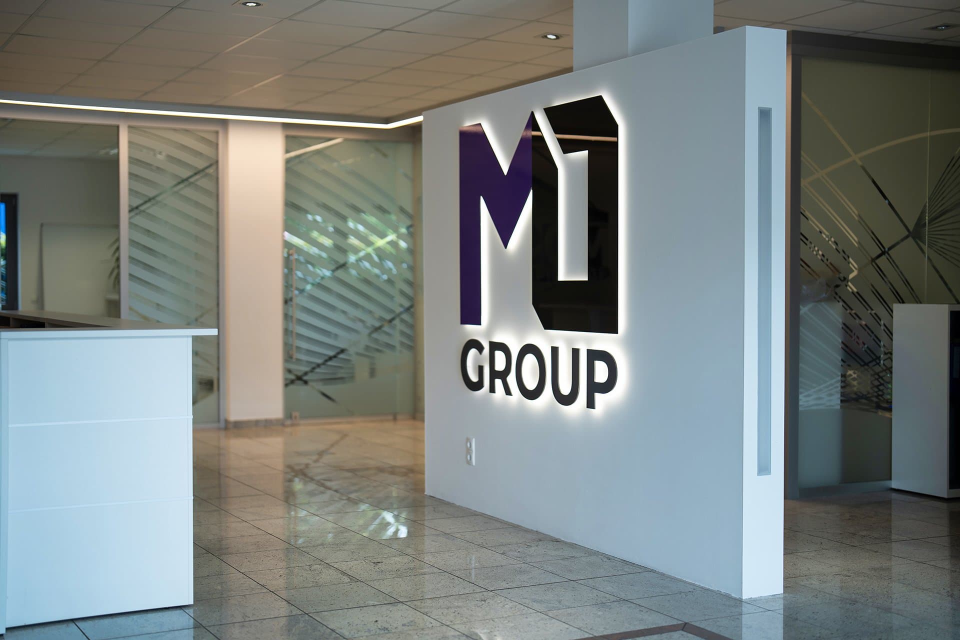 MOGROUP reception area with illuminated logo